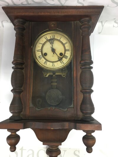 An eight day wall clock with Roman numerals to chapter ring, approx height 56cm.