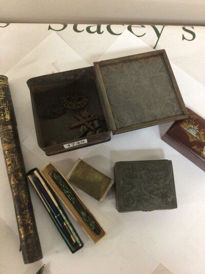 A Collection of I world war military cap badges. Including a Machine gun corp badge Australian Commonwealth military forces badge and Duke of Wellington badge also fountain pens and other oddments