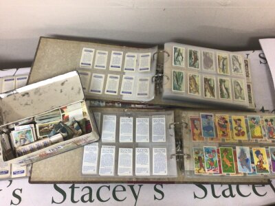 Three albums of tea cards and a tin containing loose cards.including 1992 Olympic and Disney cards.