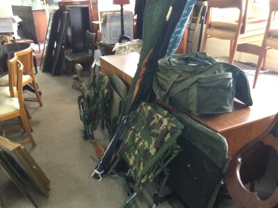 A collection of fishing gear including chairs including Wynchwood riot tactical. Rods including Shakespeare ugly stick beach, tackle etc