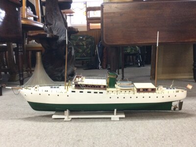 A handcrafted wooden model of a classic steam yacht. 110cm wide approximately