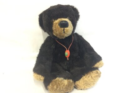 A vintage horse hair filled bear with growler, 36cm tall