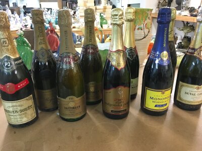 A collection of 9 bottles of assorted champagne including 1976 Taittinger, bollinger etc