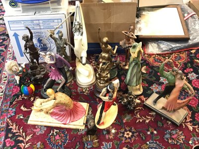 A collection of figures including art deco style examples.