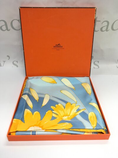 A boxed Hermes scarf.