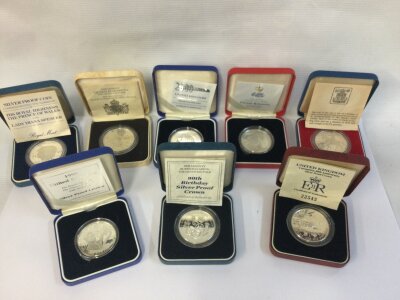 A collection of eight silver proof coins including 90th birthday crown and coronation 40th anniversary crown.