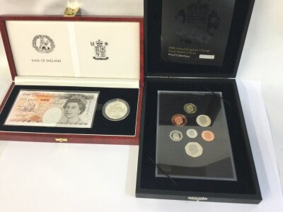 A Bank of England £10 note with commemorative coin and a royal mint 2008 proof collection