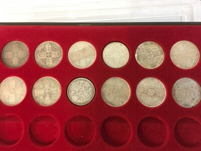12 silver florins from various years.
