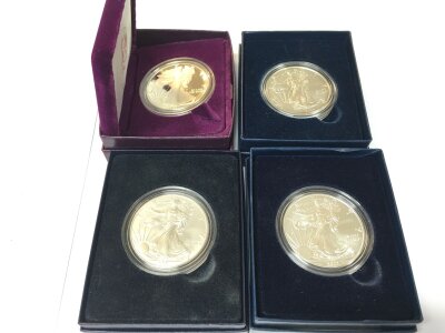 4 Boxed Silver 1Oz American Dollars.
