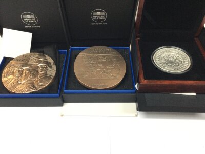 Three cased commemorative rounds including a bronze centenary of the Great War