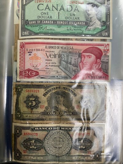 An Album of mixed world banknotes. Various denominations and conditions
