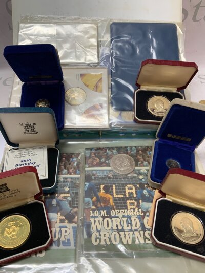 A collection of Pobjoy mint carded coins, together with cased silver proof coins and collectors coins