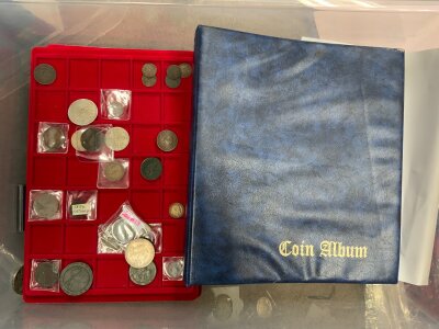 A box of mixed British and world coinage.