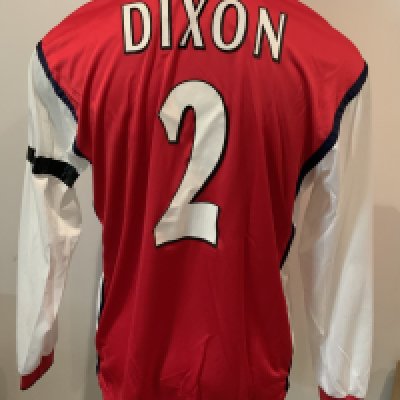 Arsenal Dixon 1999 - 2000 Match Worn Home Football Shirt: Nike red long sleeve shirt with Dreamcast sponsorship. Dixon 2 to rear. Whilst washed there is a small amount of mud marks to white sleeve and tape attached to top of left sleeve. Worn by Lee Dixon v Deportivo La Coruna on 2 3 2000 with a COA signed by him. Photographic proof on picture of him scoring the first goal.