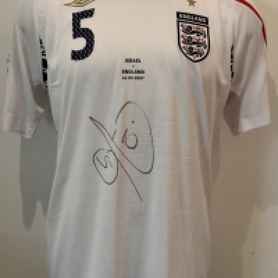 England Rio Ferdinand 2007 Match Worn Football Shirt: Umbro short sleeve shirt with Ferdinand 5 to rear and Euro 2008 badging to sleeve. Number 5 to front match details Israel v England 24 03 2007 and Rio Ferdinands autograph. Direct from top source who we know. The Manchester United player played the whole match in a 0-0 draw in Tel Aviv.