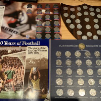 Football Coin Sets: Esso 1970 World Cup full set stuck into wooden shield that could be hand made. 1972 FA Cup Centenary is also complete in album. C/W 1998 Sainsburys full World Cup set and some other loose coins. (3 sets)