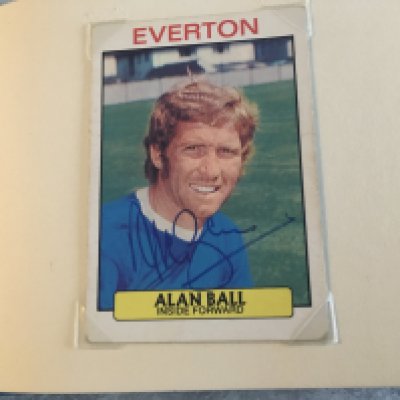 England 1966 Signed Squad Football Trade Cards: Rare chance to obtain all 22 players trade cards fully hand signed without dedication by each player plus manager Alf Ramsey. Clipped not stuck into original World Cup Willie autograph book. Most cards are by maker A+BC and feature the player in club kit. Autographs are genuine and sometimes collected in person at organised events although Bobby Moore purchased and looks a bit rushed. Stunning rare chance.