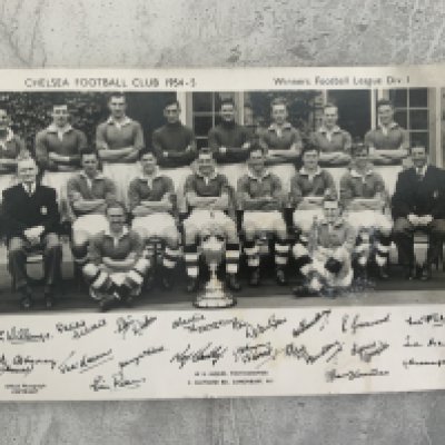 Chelsea 54/55 Framed Photo + Postcard: Division One champions original postcard. Large framed photo of an aerial shot of Stamford Bridge in the period signed to rear board of frame by 8 title winning players. Roy Bentleys autograph is dedicated but Parsons Lewis Smith Willemse Saunders Thomson McNichol etc are not. (2)