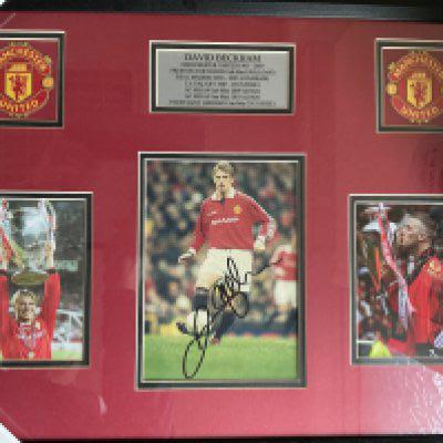 David Beckham Signed Framed Manchester United Photo: Treble season photos nicely framed with clear undedicated signature. COA to rear. Measures 21 x 17 inches.