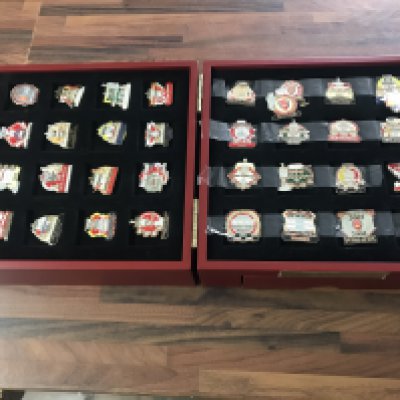 A collection of various Arsenal pin badges