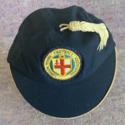 Ron Boyce West Ham London Minor FA Cap + Medal: Blue tasseled Bukta cap and gold coloured medal engraved to rear winners 1959 - 60. West Ham beat Millwall on 12 5 1960 at Barking. Both in very good condition. (2)