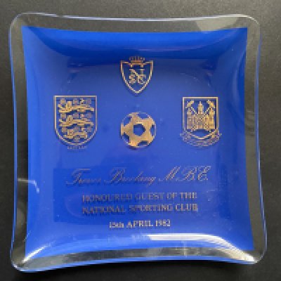 Trevor Brooking Football Memorabilia: From John Lyalls personal collection over the years to include an ashtray from the Royal Sporting Club 1982. Includes Freedom of Brentwood brochure signed by Lyall, 3 photos and Brookings testimonial programme signed by Brooking and Lyall.