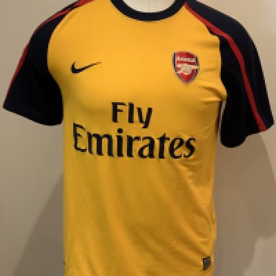 Arsenal Football Shirts: Long sleeve 2010 - 11 home red and white replica Emirates in good condition, size XL with number 9 to rear. Some stains to sleeves. Short sleeve 2008 - 2009 away yellow replica Emirates in good condition. Size medium. (2)