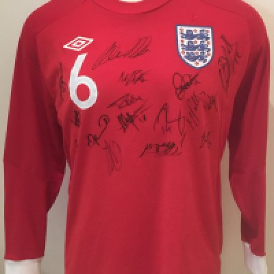 2010 England U21 Signed Football Shirt: Official England red long sleeve number 6 shirt signed by 16 players brought back by Peter Barnes the Tottenham + West Ham club secretary who travelled with the touring party. Please note this is not a match worn shirt.