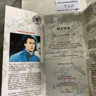 1970 England Players + Beckenbauer Signed Football Menu: Bobby Charlton Enterprises present Franz Beckenbauer menu in Manchester 1990. Signed by Beckenbauer Busby Hunt Stiles Charlton Lee and probably Stepney. Good menu signed by the 1970 England players and Manchester United friends of Bobby Charlton.
