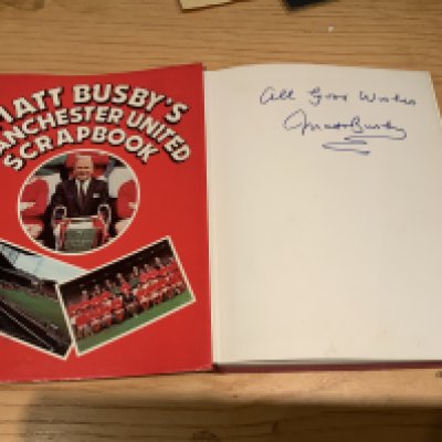 Matt Busby Manchester United Signed Football Book: Hardback book with dust jacket titled Matt Busbys Manchester United Scrapbook in excellent condition. Hand signed All Good Wishes without dedication.