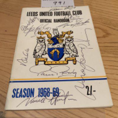 1968 - 1969 Leeds United Signed Football Handbook: COA from reputable source states it is signed to cover by Reaney Gray Hunter Jones Clarke Giles Yorath Bates Lorimer and Harvey.