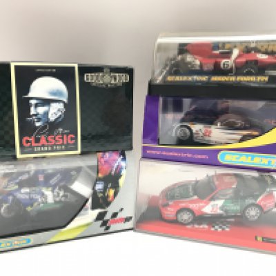 A Collection of Boxed Scalextric Cars including a SCX Ferrari 530 Maranello. A March Ford 721. A Dodge Viper.Vanwall F1 1957 Stirling Moss. And A Moto GP Movistar Honda Bike.