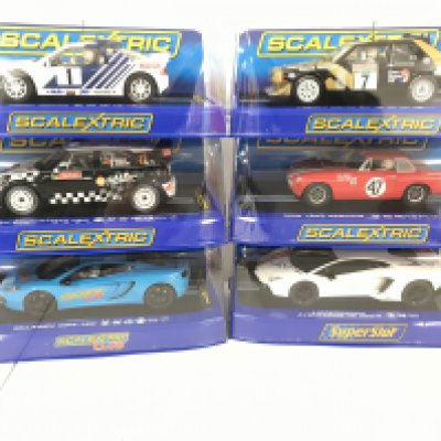 6 X Boxed Scalextric Cars. Including a Ford RS200. A Lancia Delta. A Mini Countryman WRC. A MGB 1964. A McLaren MP4-12C and a Lamborghini.