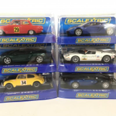 6 Boxed Scalextric Cars including a Ford Cortina. 2 X McLaren MP4-12C. A Ford GT-R. A Bugatti Veyron and a Volkswagen Beetle.