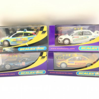 4 X Boxed Scalextric Cars. A Dodge Viper. A Peugeot 307. A Mitsubishi Lancer Evo and a Ford Focus Police Car.