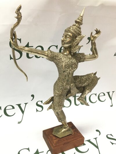 A good silver plated figure of a Tibetan figure holding a bow on one leg, 36cm tall