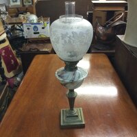 An oil lamp with bras base, a swirled marble effect glass font and an acid etched glass floral shade, 63cm tall