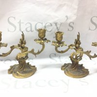 A pair of French ormoulo candelabras, approximately 15cm tall. 21cm wide.