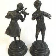 A bronze pair of figures a girl playing a violin and boy with flute , 25cm tall. NO RESERVE