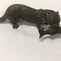 A cast bronze figure in the form of a otter with fish in mouth . 16 cm .NO RESERVE