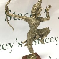 A good silver plated figure of a Tibetan figure holding a bow on one leg, 36cm tall