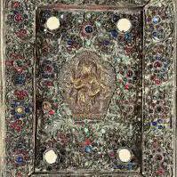 A Gilt Copper Votive Plaque Tibet / Nepal, Late 19th Century Centred by a seated Buddha on lotus base, with all over floral inlaid stone sprays, within a rectangular panel, and floral stone inlaid border. 20cm x 15.4cm. Prov. From the estate of Maharaja Bahadur of Burdwan" refered to as Sir Bijay Chand Mahtab , gifted to the vendors mother from the Maharaja of Burdwan in 1940 - (see attached gift card ). She said she'd admired it hanging on the wall at his Palace Residence - she first visited there early/mid 1930s. Whilst living, working near by and then married in India and became close to the Maharaja and his family until his death.