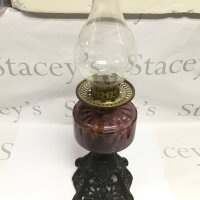 An oil lamp with a purple glass reservoir, approx height 54cm.