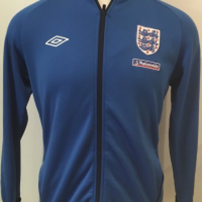 England Signed Football Shirts + Track Suit Top: 3 different era white home England shirts all signed without dedication by Tottenhams Ledley King. A further England shirt is signed by Hoddle and Peter Taylor. These were signed at a Spurs dinner. C/W a lovely blue 90s Nationwide large track suit top with mark to rear and a Score Draw replica England shirt. (6)