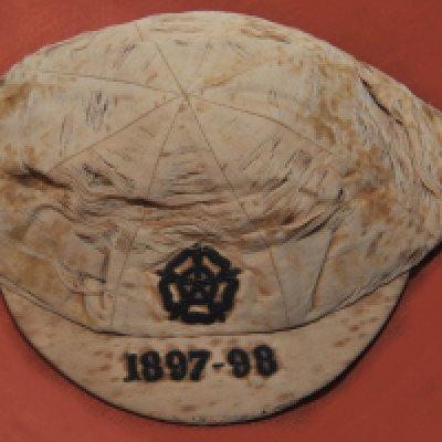 Billy Williams West Brom 1897 - 1898 England Football Cap: Full International match which ended Ireland 2 England 3 played in Belfast which was Billys 2nd full cap. Wear and discolouration to cap that was made by Foster + Co. Peak is embroidered 1897-98.
