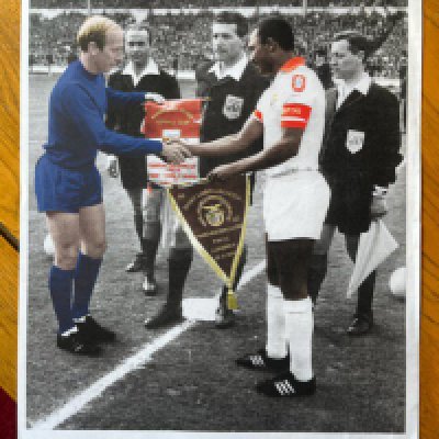 1968 European Cup Final Manchester United Football Print: 31 x 22 inch quality Becket print depicting the captains exchanging pennants at Wembley. Given to a member of the Association of Manchester United Former players. Hard to obtain unsigned poster with quote from Bobby Charlton.