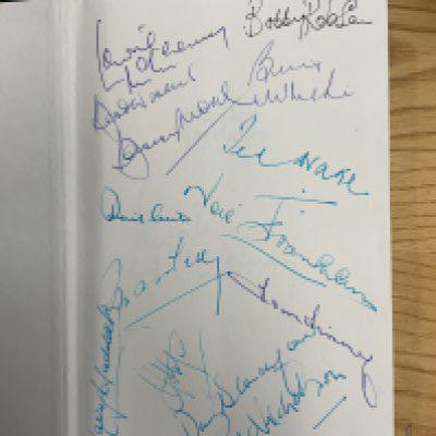 England Legends Signed Football Book: Do not miss this rare opportunity. Stanley Matthews 1989 book signed and dedicated by him. On another page is Lawrie McMenemy. On a blank first page some incredible names have signed who apart from Harry Haddock and Danny Blanchflower were Englands greatest players. Includes Bobby Moore Bobby Robson Bill Nicholson Neil Franklin Ted Drake Billy Wright and more.