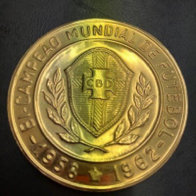 1970 World Cup FIFA Gold Football Medal: To celebrate winning the World Cup for the 3rd time the Brazil team including Pele Felix Rivellino Tostao etc attended an event held by FIFA. The same medal was presented to English referee Ken Aston who was in charge of referees for the whole tournament and fundamental in bringing in new ideas including red and yellow cards to the World Cup tournament. The medal we have been advised is 21carat Brazilian gold weighing 101 grammes and its 5cm diameter is hallmarked. Rare medal indeed.