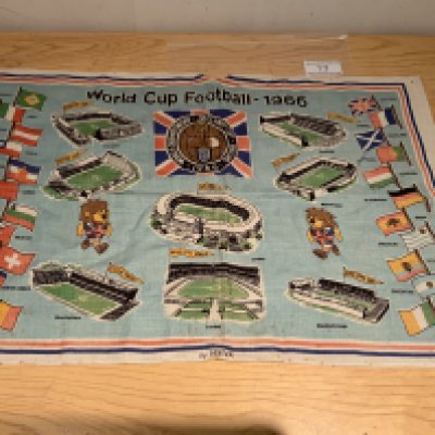 1966 World Cup Willie Football Tea Towel: Depicts flags of the 16 participating nations, pictures of all 8 venues, the World Cup 66 logo and of course WC Willie. Original pure Irish linen measuring 30 x 19 inches. Football Association copyright 1965 to corner. Good condition with a few age spots.