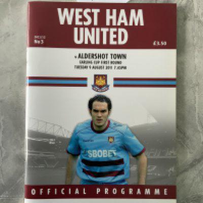 2011 - 2012 West Ham v Aldershot Postponed Football Programme: Carling Cup dated 9 8 2011 in mint condition. Rare as postponed due to Tottenham riots and a destruction certificate was issued meaning all programmes should be pulped.